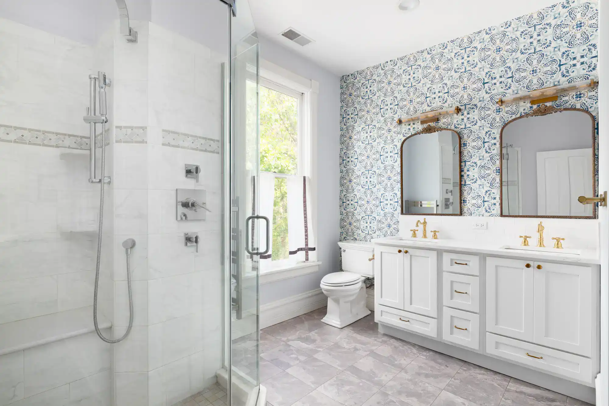 Elegant bathroom with walk-in shower and double vanity.