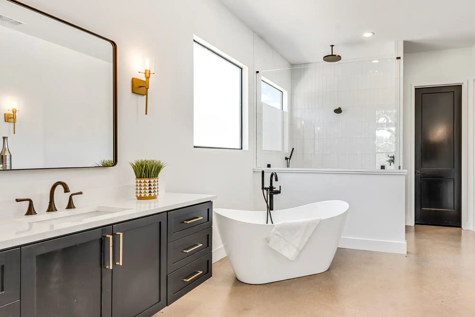 Contemporary bathroom with freestanding tub and sleek vanity.