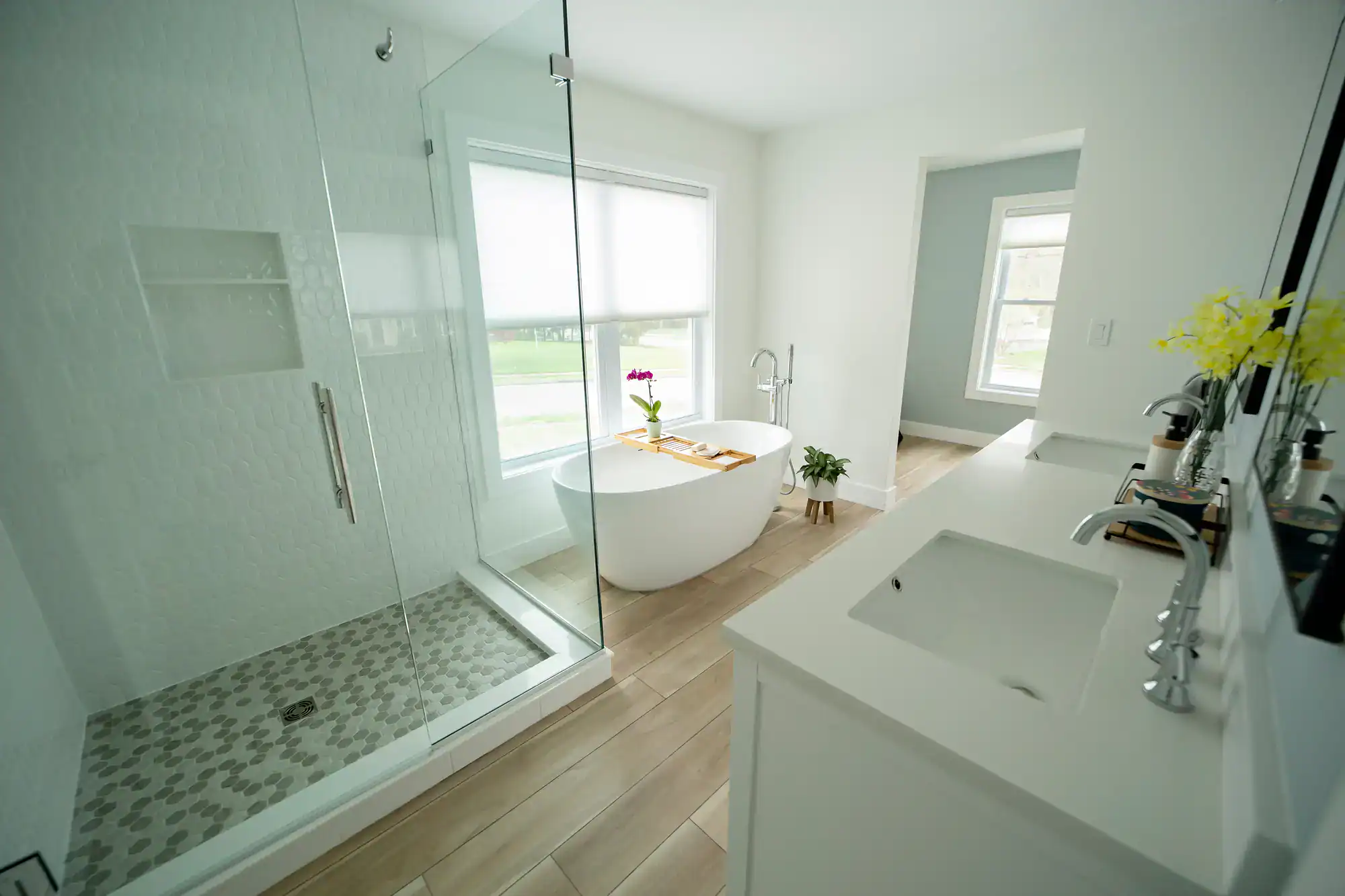 Bright bathroom with walk-in shower and freestanding tub.