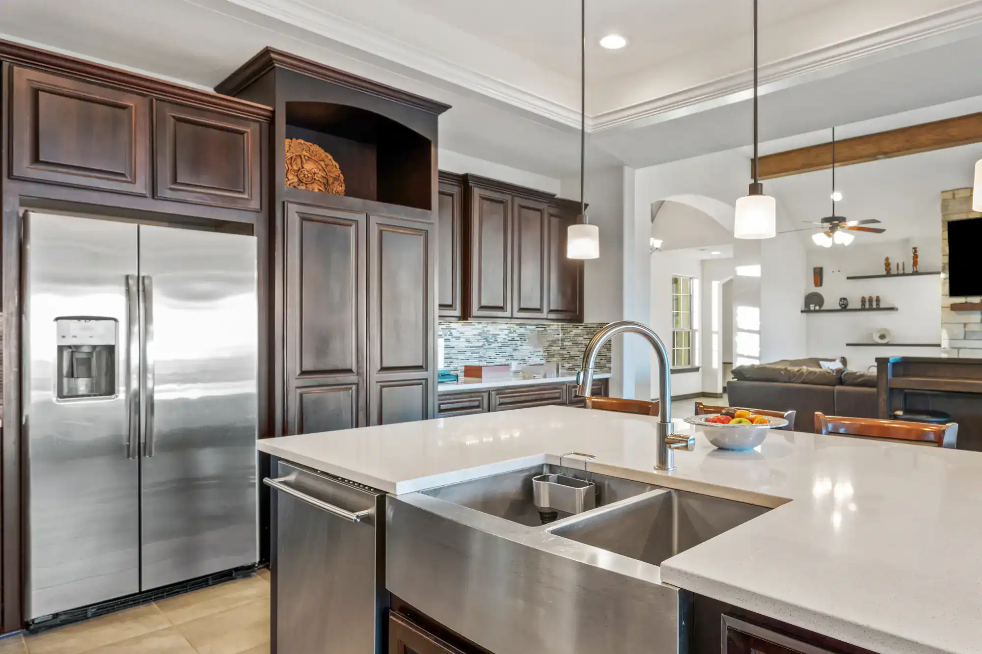 Contemporary kitchen with dark wood cabinets and stainless steel appliances.