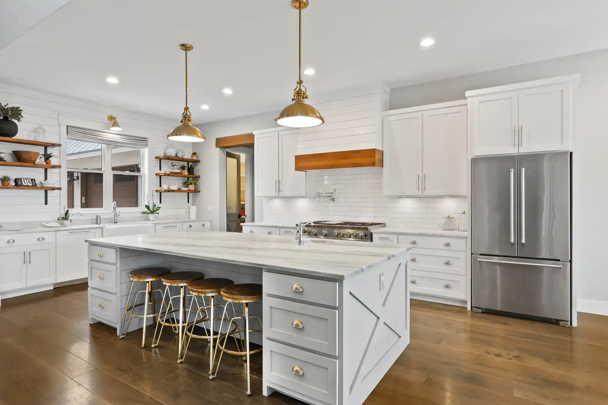 Contemporary kitchen with white cabinets, island, and stainless steel appliances.